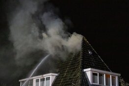 Brand in dak van woning in Huizen