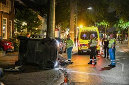 Auto belandt op z'n kant in Hilversum, schade enorm